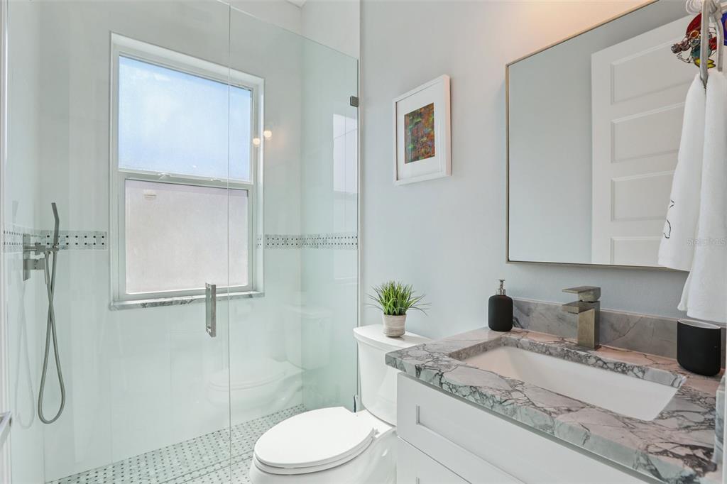 352 Mehlenbacher Road Belleair, FL 33756 - Photo 31 of 88 a bathroom with a granite countertop sink a toilet and shower