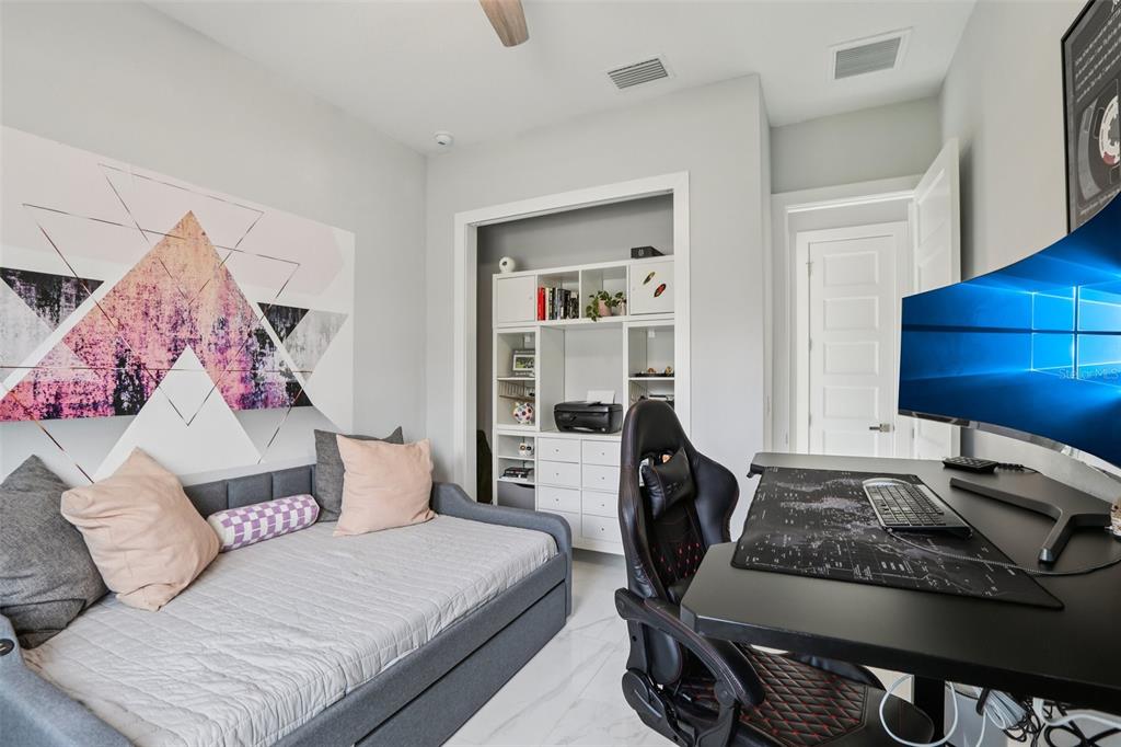 352 Mehlenbacher Road Belleair, FL 33756 - Photo 33 of 88 a bedroom with a bed and a walk in closet