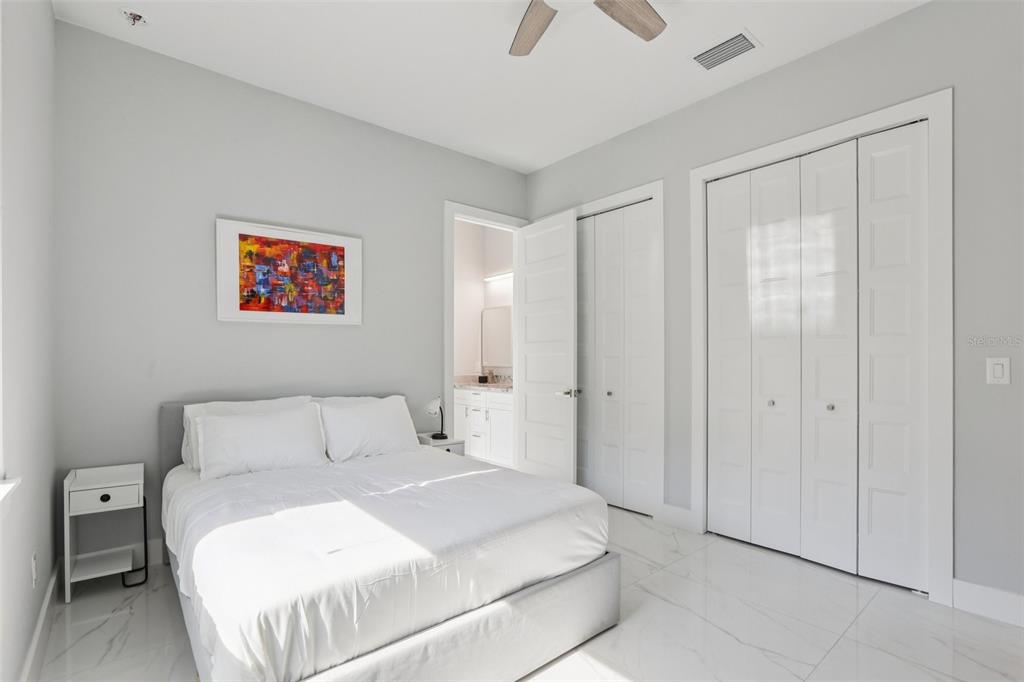352 Mehlenbacher Road Belleair, FL 33756 - Photo 39 of 88 a bedroom with a bed and a painting