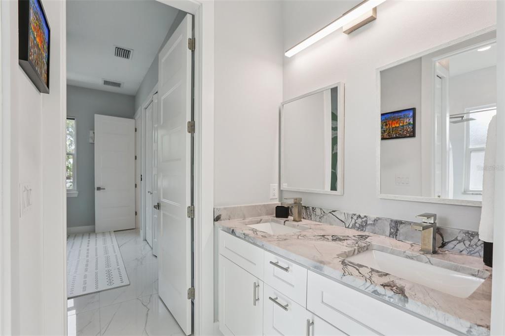 352 Mehlenbacher Road Belleair, FL 33756 - Photo 42 of 88 a bathroom with a granite countertop sink mirror and a shower