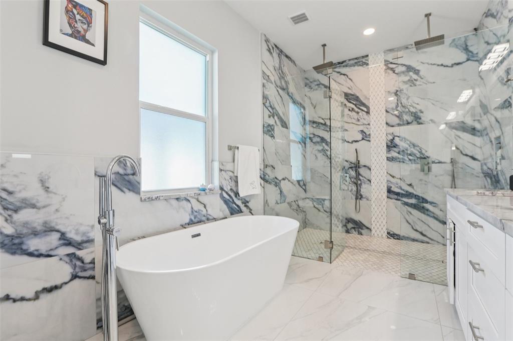 352 Mehlenbacher Road Belleair, FL 33756 - Photo 52 of 88 a white bath tub sitting next to a shower