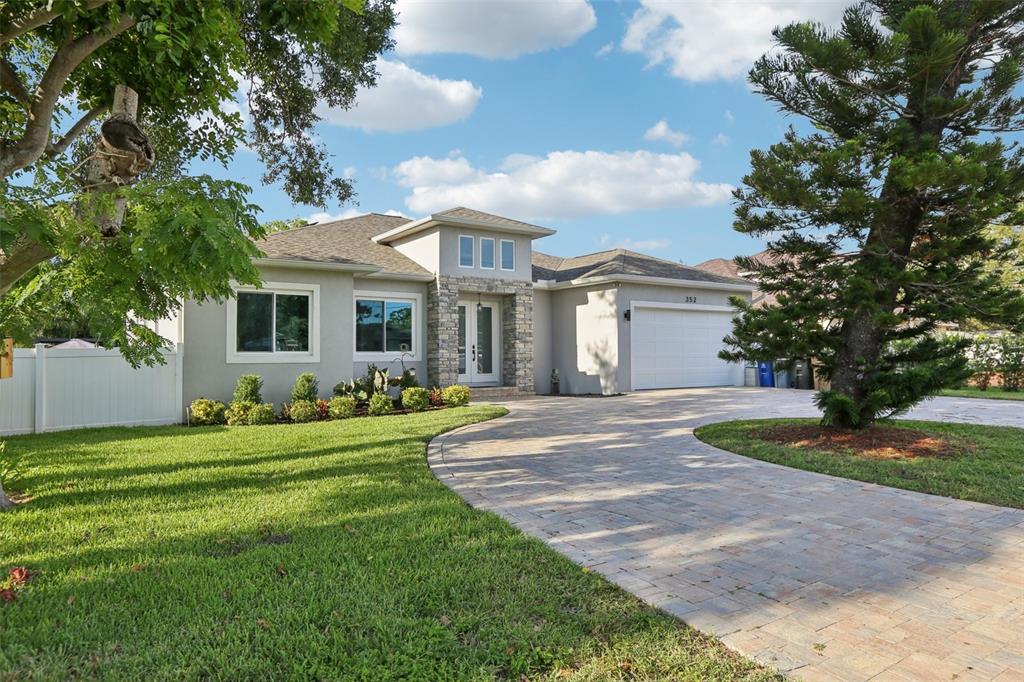 352 Mehlenbacher Road Belleair, FL 33756 - Photo 6 of 88 a front view of a house with a yard and trees