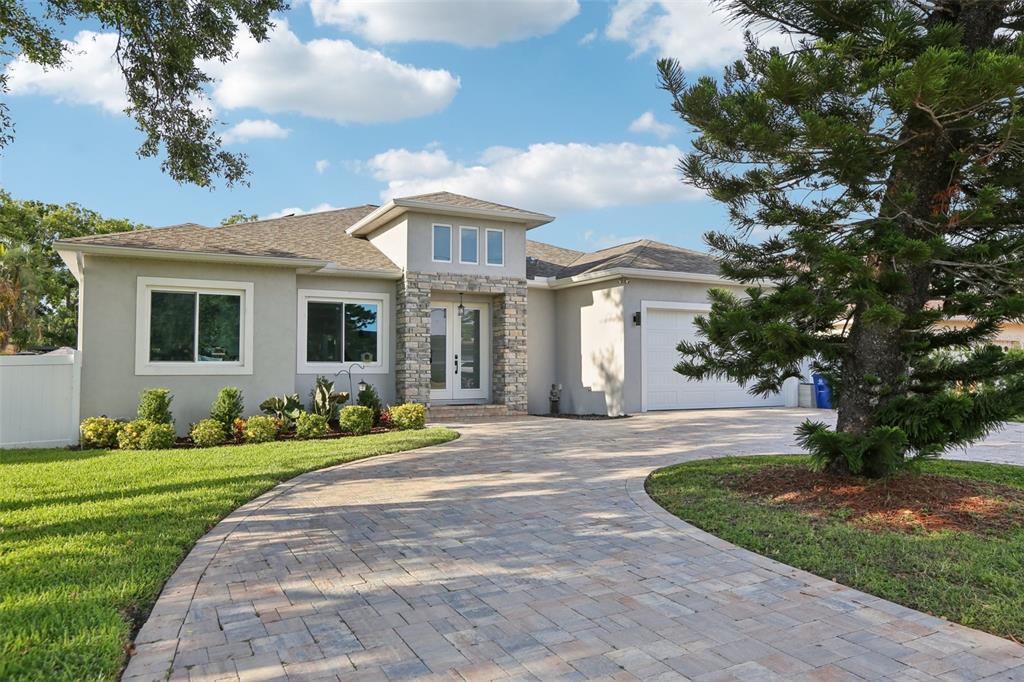 352 Mehlenbacher Road Belleair, FL 33756 - Photo 7 of 88 a front view of a house with a yard and potted plants