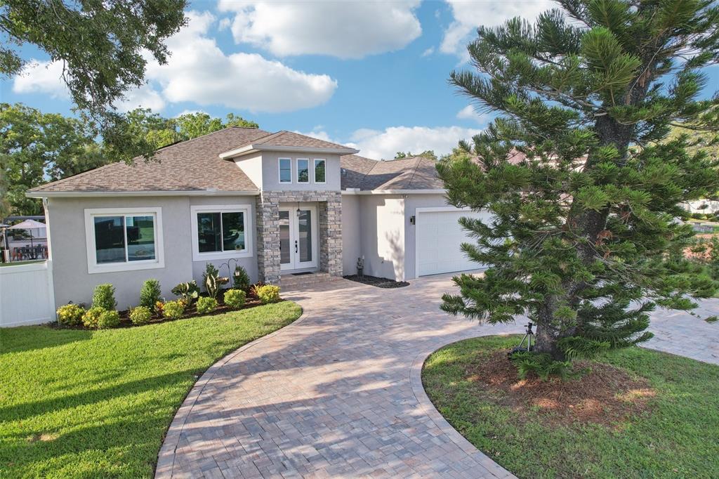 352 Mehlenbacher Road Belleair, FL 33756 - Photo 71 of 88 a front view of a house with a garden