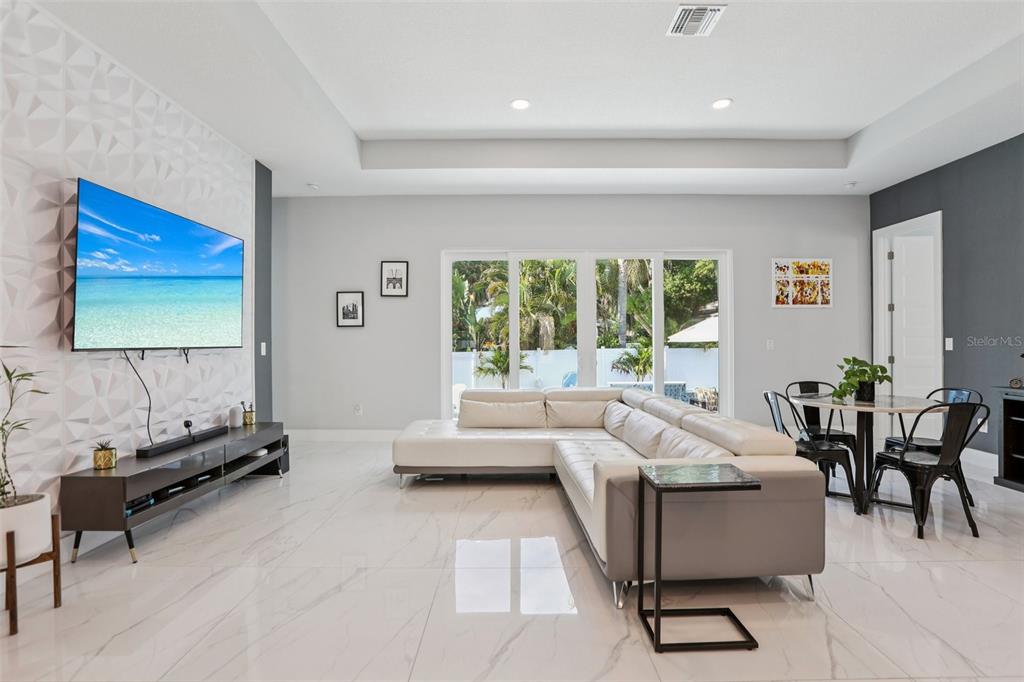 352 Mehlenbacher Road Belleair, FL 33756 - Photo 10 of 88 a living room with furniture and a flat screen tv