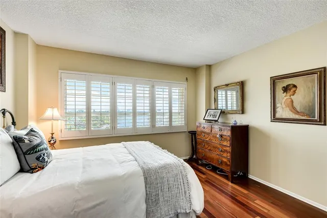 a bedroom with a large bed and a large window