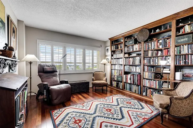 a bedroom with furniture and a book shelf
