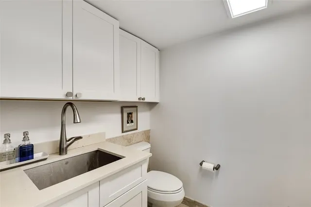 a view of a sink and a toilet in a kitchen