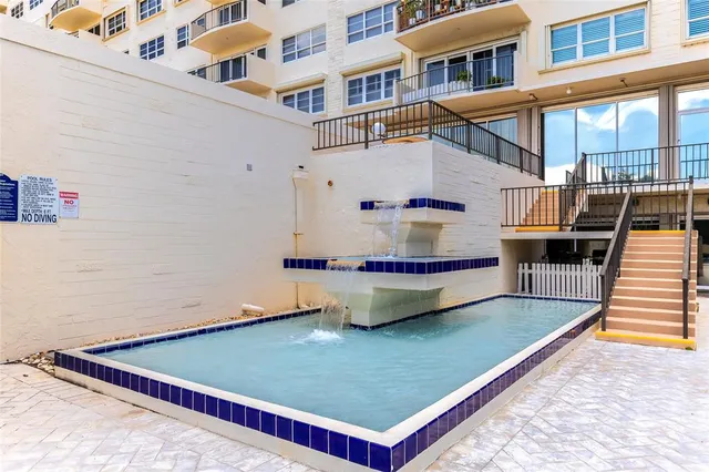 a view of a pool with sitting area