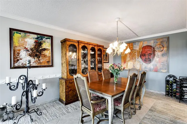 a view of a dining room with furniture one side kitchen view and wooden floor