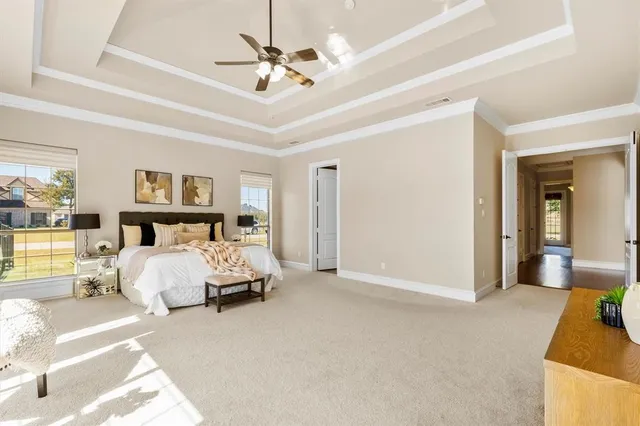 a spacious bedroom with a bed and a couch