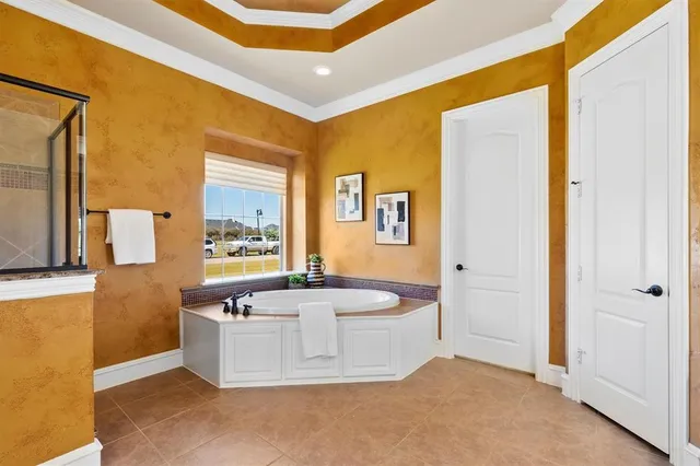 a spacious bathroom with a tub and mirror