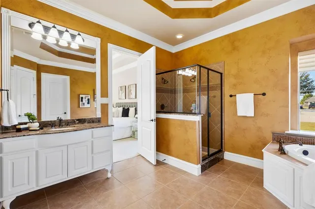 a spacious bathroom with a mirror a sink and a bathtub