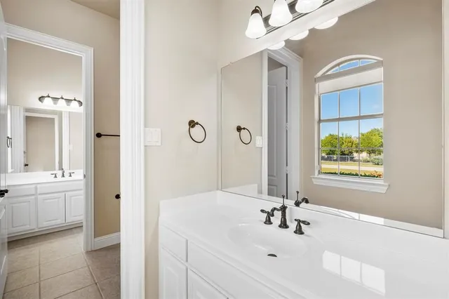 a bathroom with a sink a large mirror and a bathtub