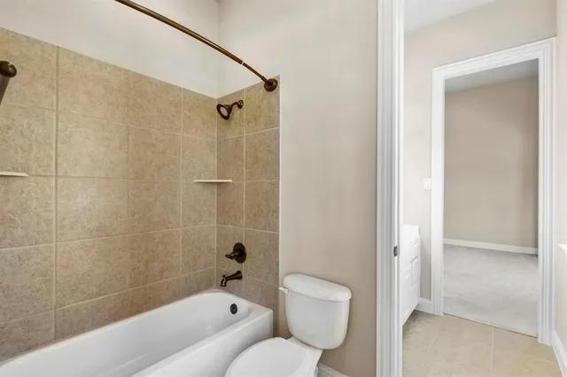 a bathroom with a toilet and a bathtub
