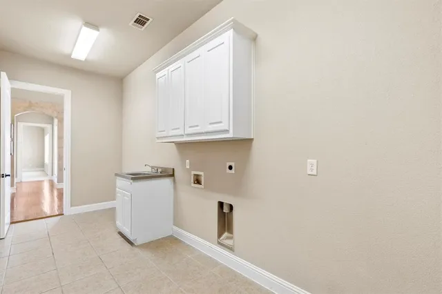 a kitchen with granite countertop a sink and cabinets