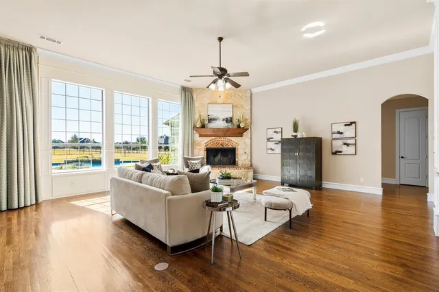 a living room with fireplace furniture and a wooden floor