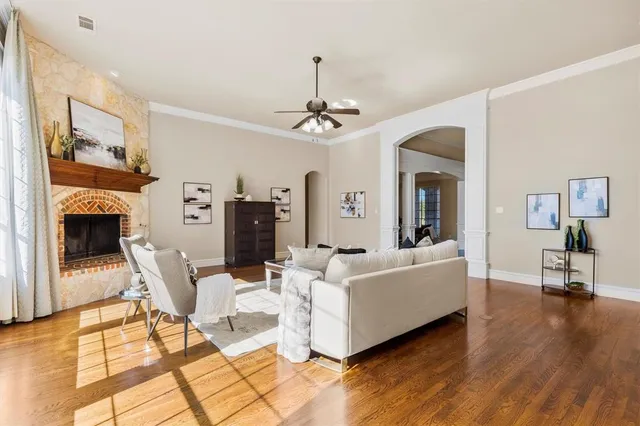 a living room with furniture a fireplace and a chandelier