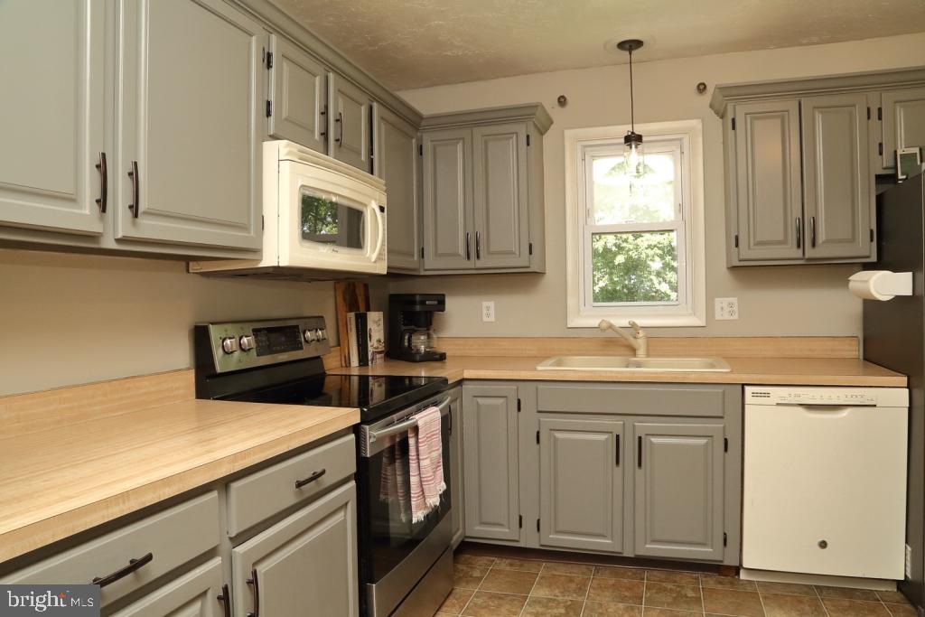 141 Frogtown Road Pequea, PA 17565 - Photo 6 of 28 a kitchen with cabinets appliances a sink and a window
