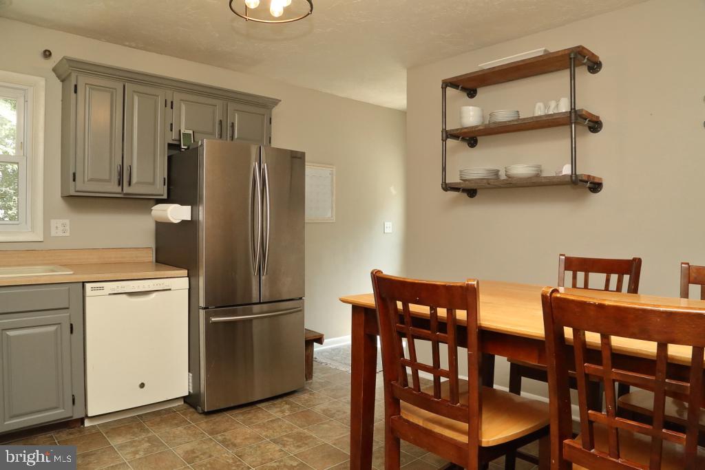 141 Frogtown Road Pequea, PA 17565 - Photo 7 of 28 a kitchen with stainless steel appliances granite countertop a dining table and chairs