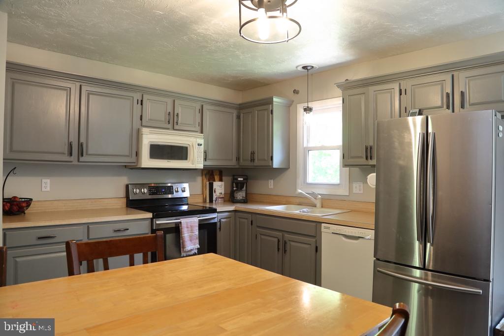 141 Frogtown Road Pequea, PA 17565 - Photo 10 of 28 a kitchen with stainless steel appliances granite countertop a sink stove and refrigerator