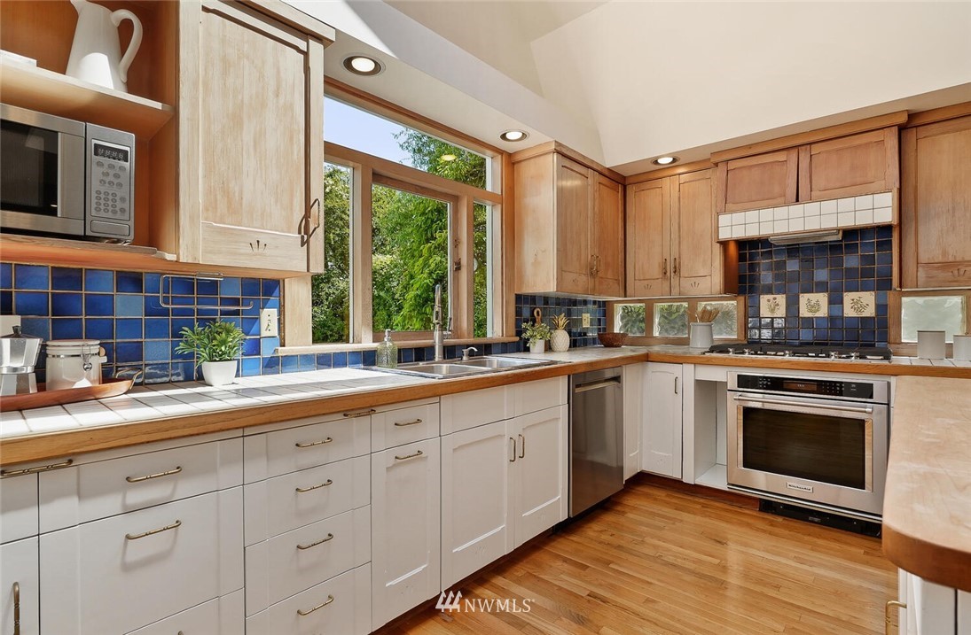 5124 1st Avenue Northwest Seattle, WA 98103 - Photo 11 of 35 a kitchen with sink cabinets and window