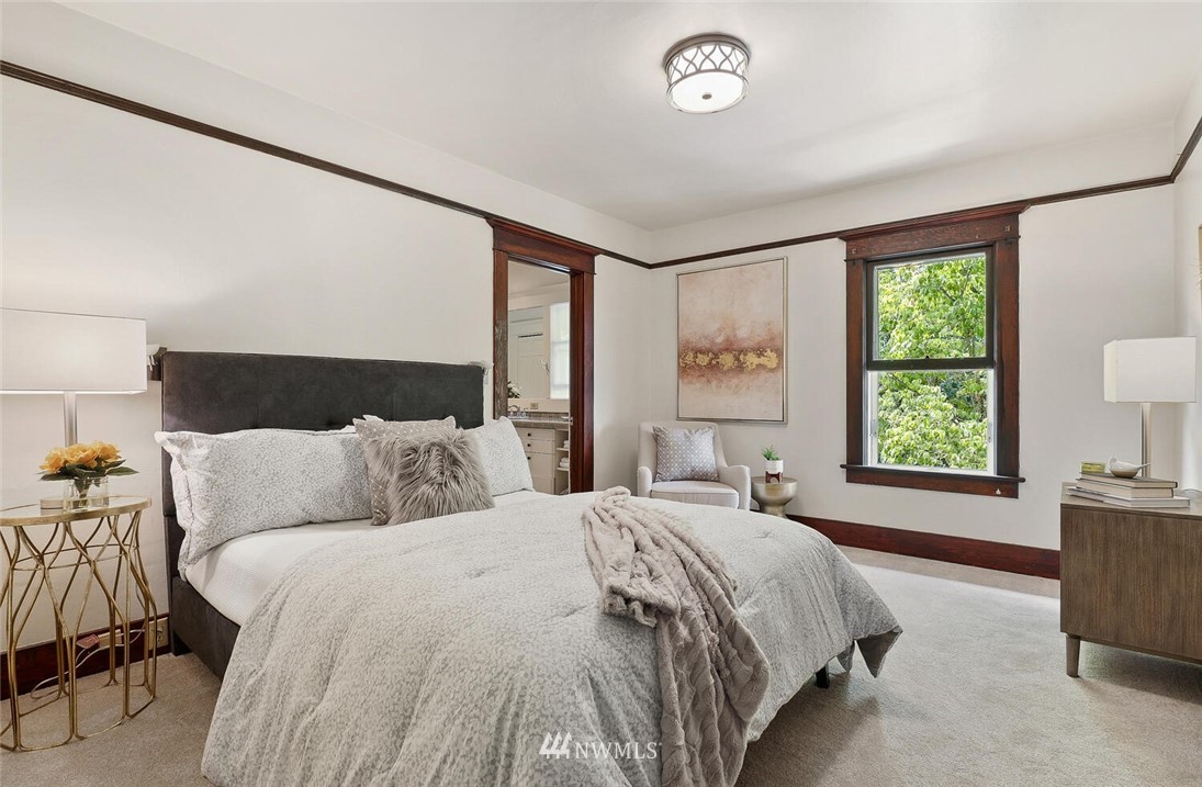 5124 1st Avenue Northwest Seattle, WA 98103 - Photo 17 of 35 a bed sitting in a bedroom next to a window