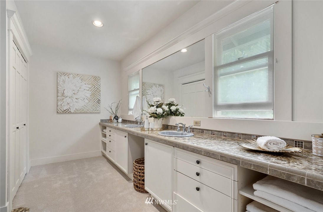 5124 1st Avenue Northwest Seattle, WA 98103 - Photo 19 of 35 a spacious bathroom with a granite countertop sink and a mirror