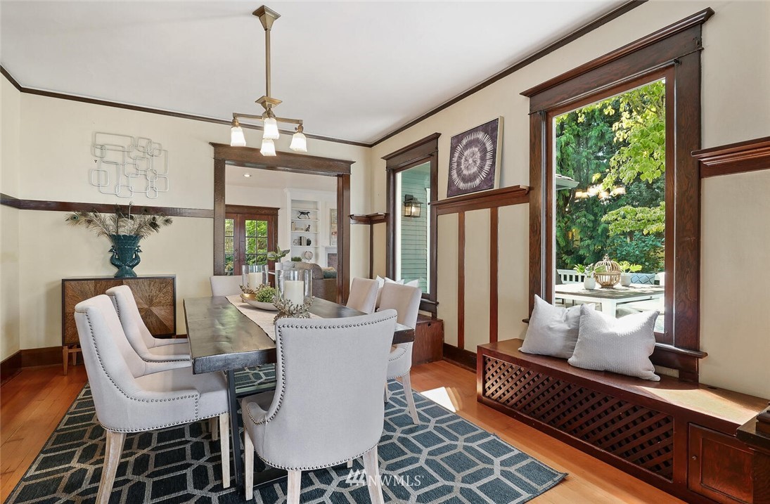 5124 1st Avenue Northwest Seattle, WA 98103 - Photo 7 of 35 a dining room with furniture a chandelier and wooden floor