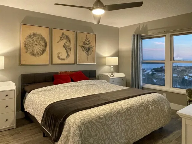 a bedroom with a bed and a painting on the wall