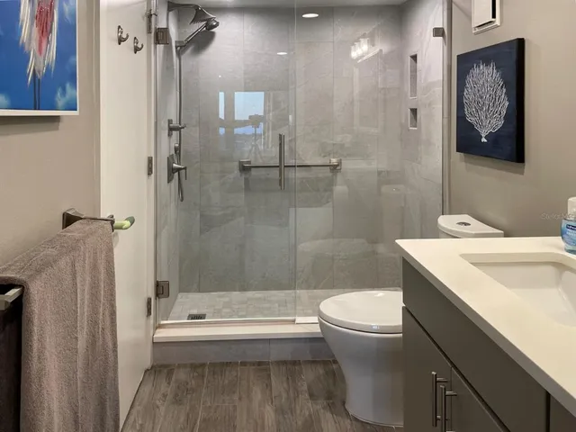 a bathroom with a shower and a mirror