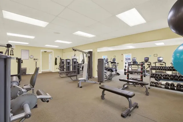 a room with pool table and windows