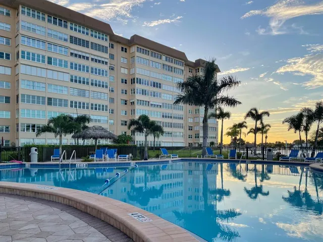 a view of a swimming pool with a table and chairs