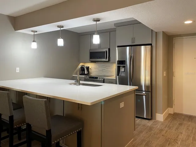 a kitchen with stainless steel appliances a refrigerator and a stove