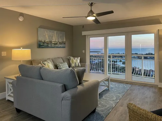 a living room with furniture and a floor to ceiling window