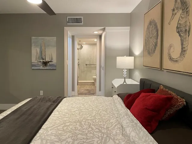 a bedroom with a bed and a lamp