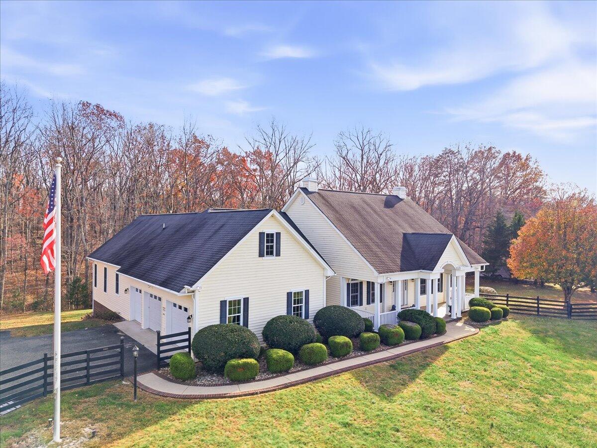 a view of house with yard and entertaining space