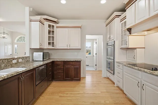a view of a room with wooden floor and white walls