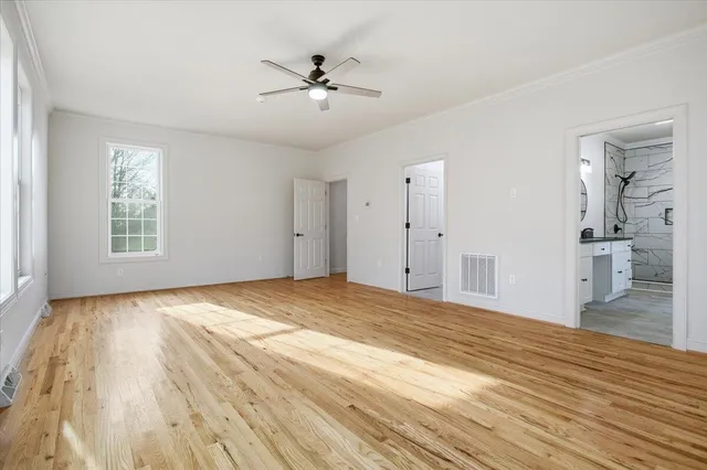 a view of backyard with a barn and large trees