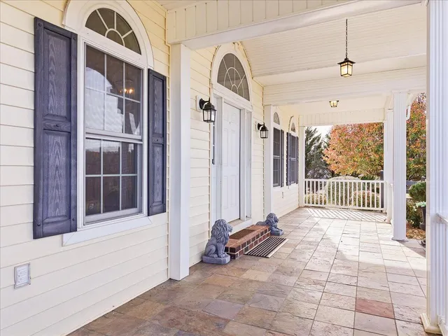 a view of empty room with wooden floor and windows