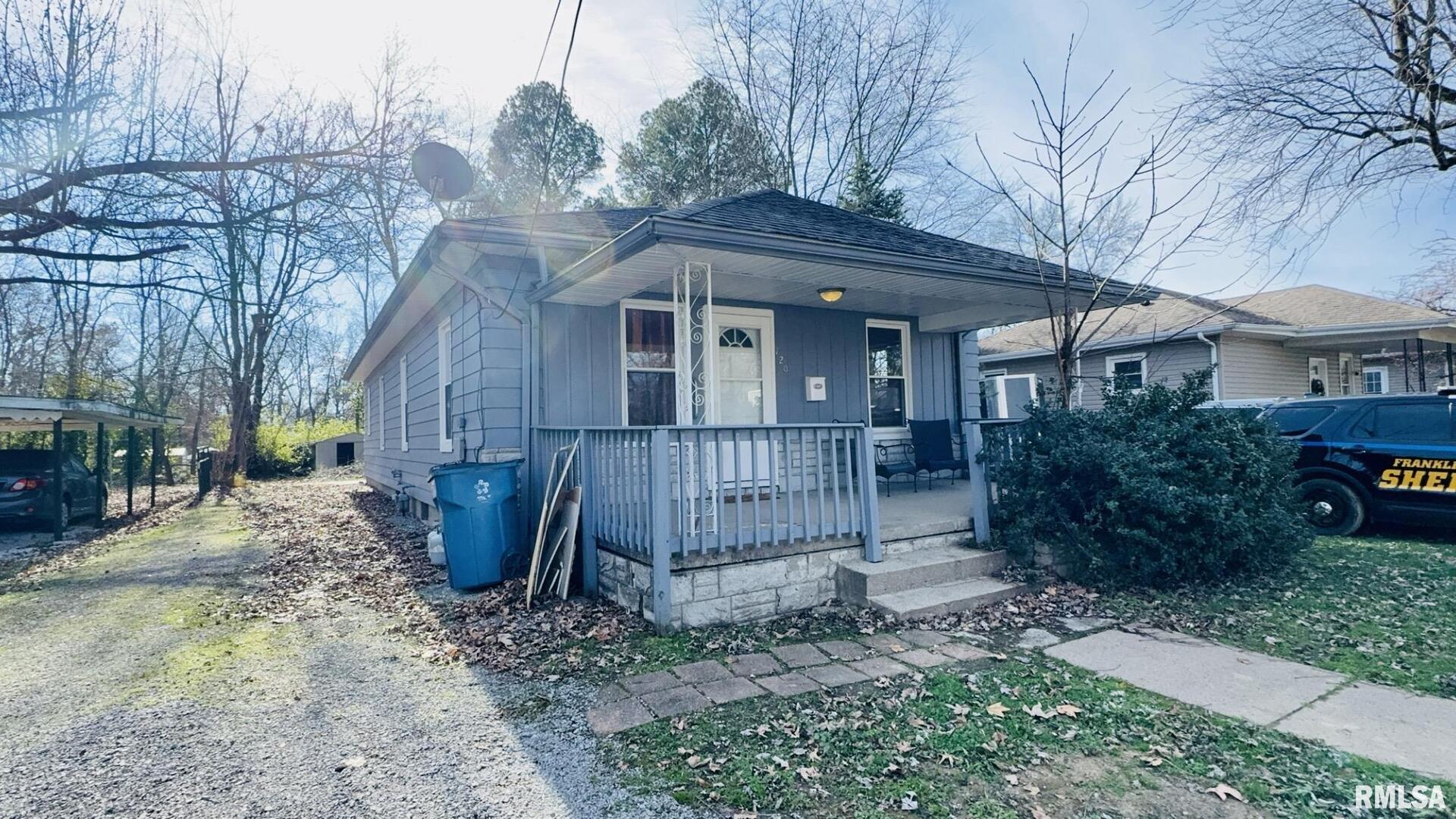 a view of a house with a yard and wooden fence