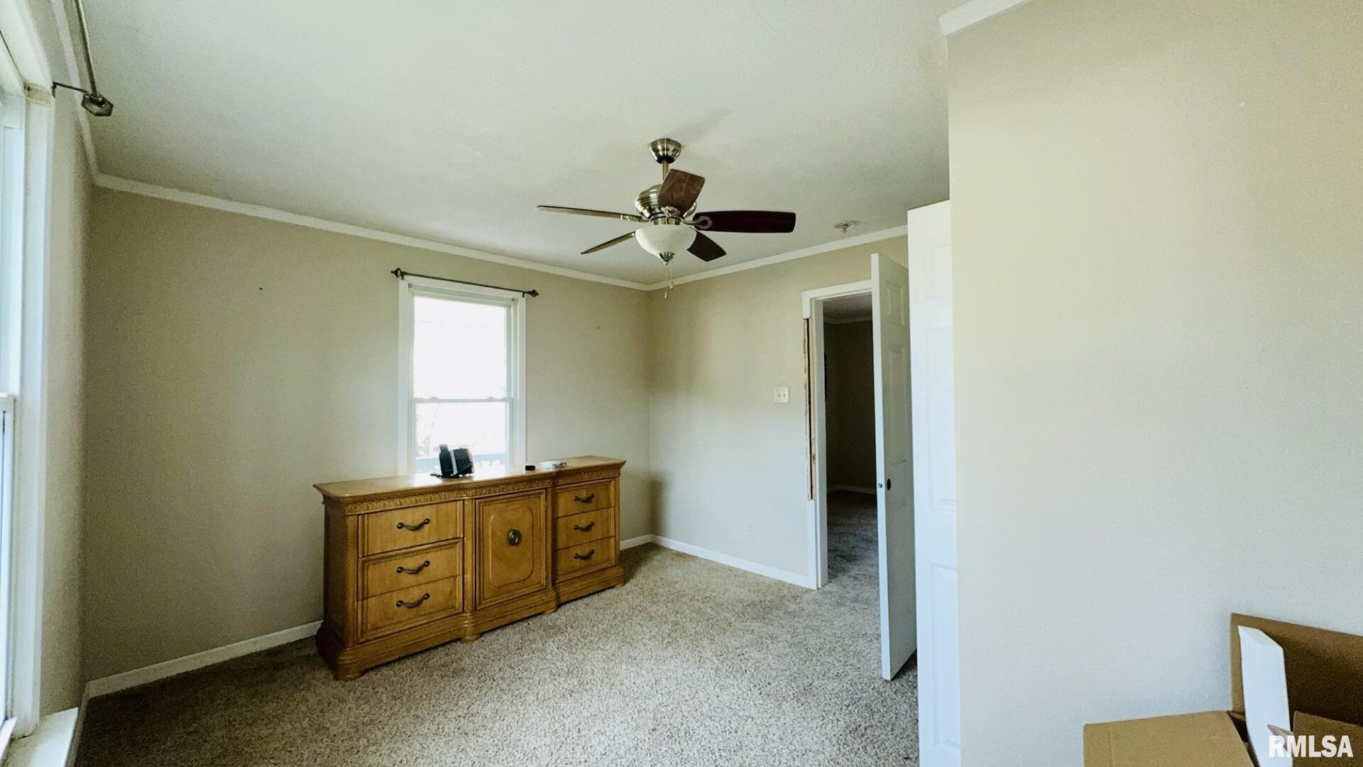 720 East Taylor Street Benton, IL 62812 - Photo 15 of 19 a bedroom with a bed and a chandelier fan