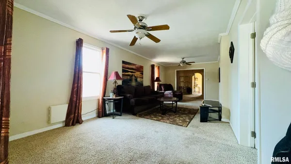 a living room with furniture and a ceiling fan
