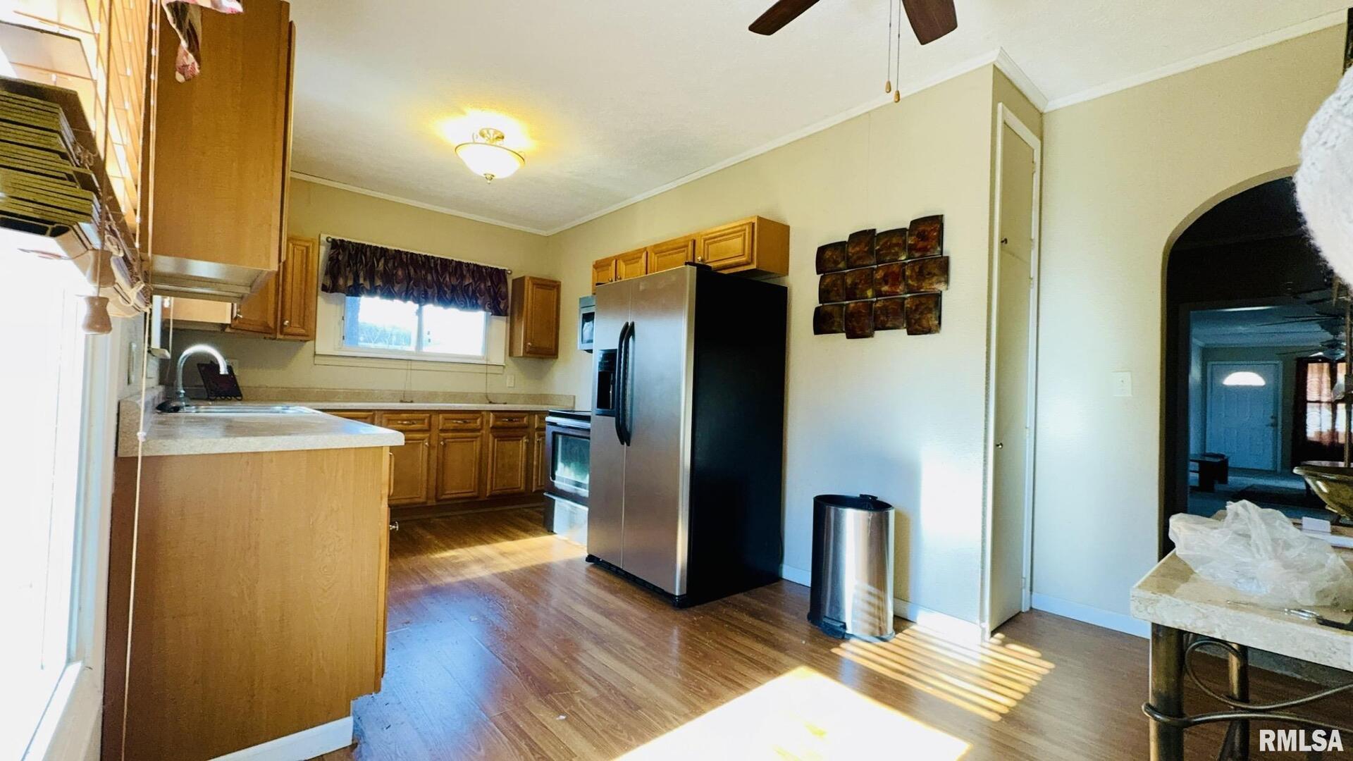 720 East Taylor Street Benton, IL 62812 - Photo 9 of 19 a kitchen with stainless steel appliances granite countertop a refrigerator a stove and a sink with wooden floor