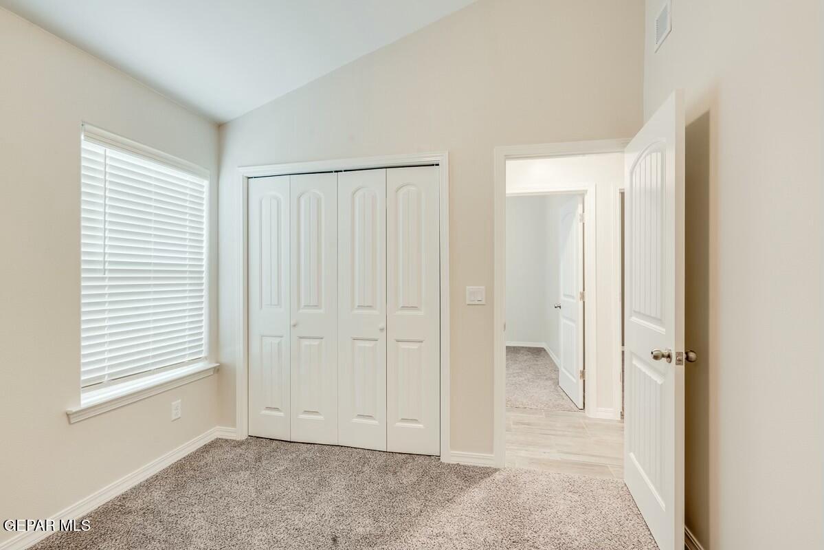 6058 Fall Ridge Street Sunland Park, NM 88008 - Photo 18 of 26 an empty room with windows and closet