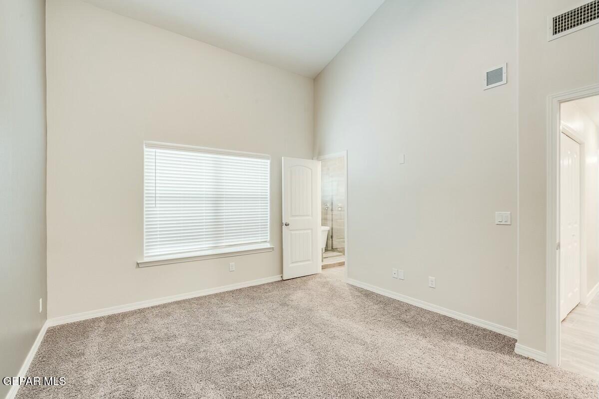 6058 Fall Ridge Street Sunland Park, NM 88008 - Photo 21 of 26 an empty room with a empty space and windows