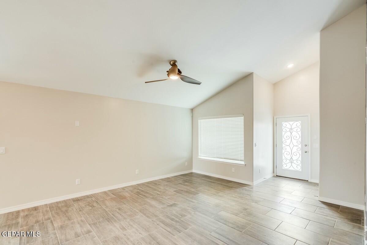 6058 Fall Ridge Street Sunland Park, NM 88008 - Photo 10 of 26 an empty room with wooden floor and ceiling fan