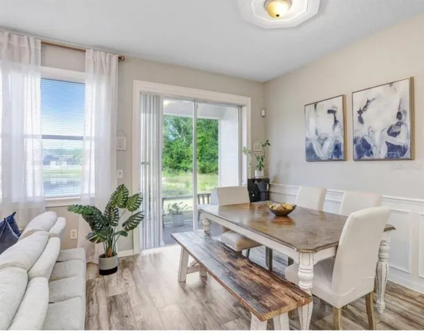 a dining room with furniture and wooden floor
