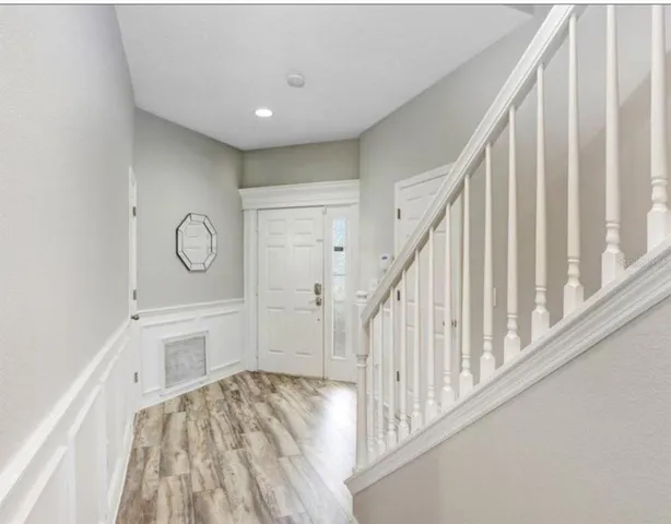 a view of a hallway view with wooden floor and staircase
