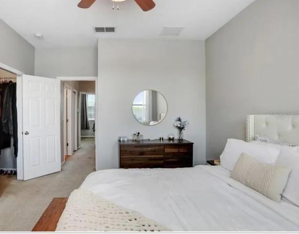 a bedroom with a bed and a mirror